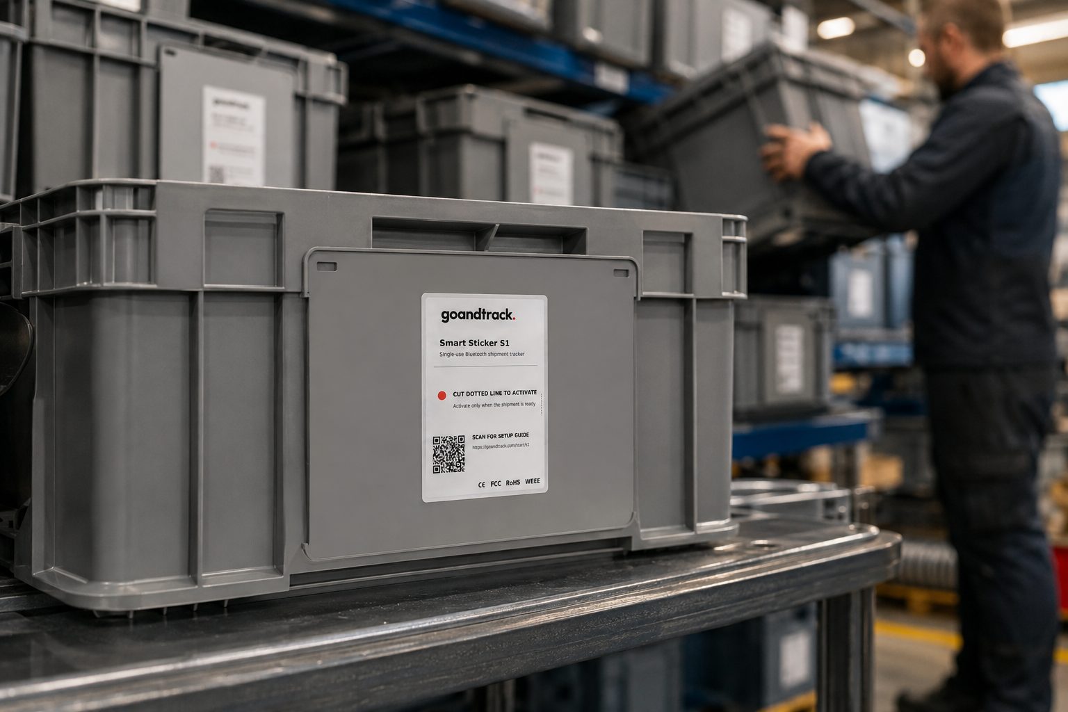 GNTS1 Smart Sticker S1 on a grey returnable transit tote among stacked containers